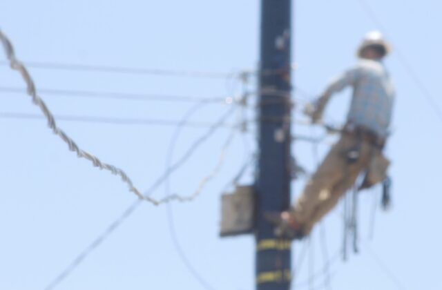 blurry-photo-of-utility-worker-on-a-pole-2021-09-03-10-05-04-utc
